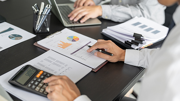 Business women checking annual financial statements of company